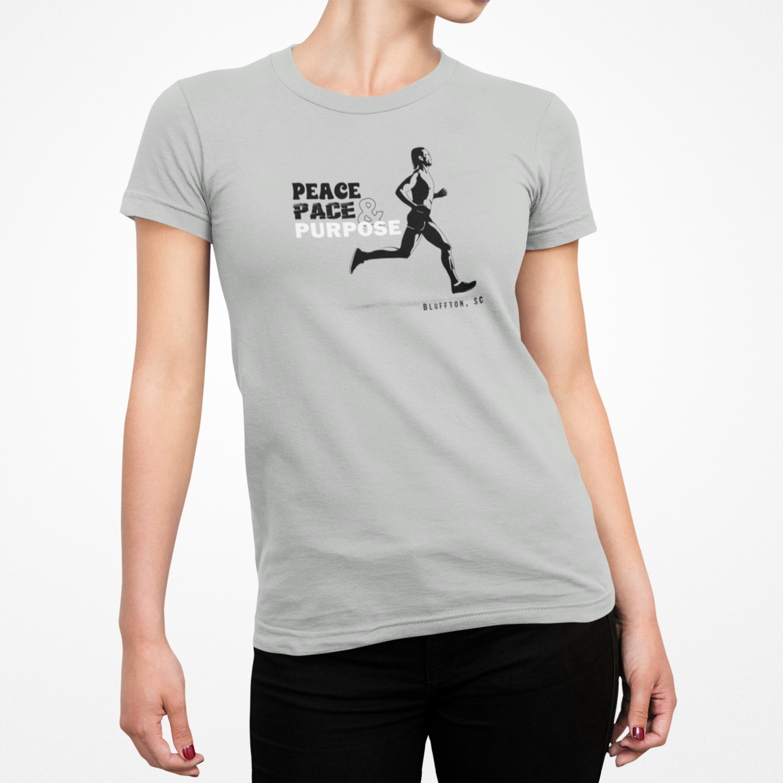 Person wearing a gray t-shirt with a black and white graphic and text on a white background with the saying Peace Pace & Purpose
